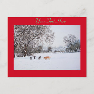 Postal perros jugando con el paisaje de la nieve del invi