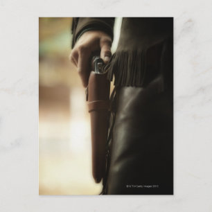 Postal Vaquero con arma en el agujero