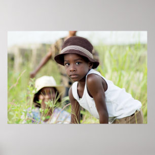 Póster Injured child in the grass.