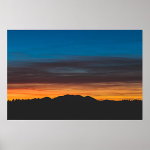 Póster La puesta de sol ardiente sobre la silueta paisají