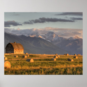 Póster Old barn framed by hay bales and dramatic