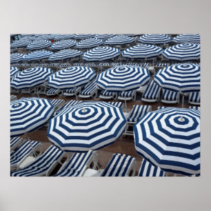 Póster Rows Of Striped Beach Umbrellas With Sun Beds