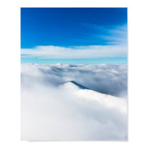 Snowy winter mountain wrapped in clouds