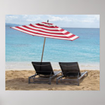 TWO BEACH CHAIRS UNDER AN UMBRELLA