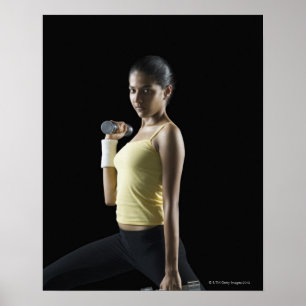 Póster Young woman exercising with dumbbells