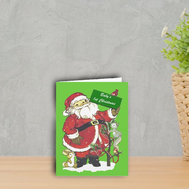 Primera foto de Santa del navidad del bebé (Happy Santa with forest animals decoration tree in snow on green Baby's 1st Christmas greeting card.)