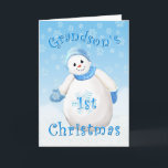 Primera tarjeta de felicitación de Snowman para na<br><div class="desc">Una ráfaga de copos de nieve rodea a este sonriente muñeco de nieve adornado con un gorra azul difuso y mitones. Un delicioso diseño de Navidades para la primera tarjeta de felicitación navideña de tu nieto. Personalice el versículo interior utilizando la plantilla proporcionada. Me especializo en diseños hechos a personalizado,...</div>
