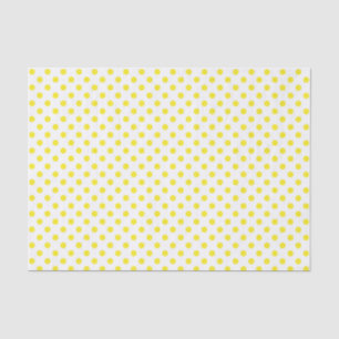 Punto amarillo de polka en papel blanco