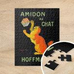 Puzzle Amidon Au Chat | Leonetto Cappiello<br><div class="desc">Amidon Au Chat (1903) | Leonetto Cappiello’s vintage advertising poster Amidon Au Chat for Hoffman features a whimsical orange cat playfully interacting with a box of starch, set against a striking black background. The vibrant orange of the cat and the bold typography create a high-contrast design that is both eye-catching...</div>