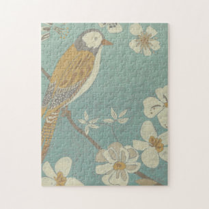 Puzzle Ave amarilla, gris y beige colocada en una rama