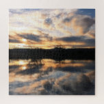 Puzzle Beautiful Winter Sunset over Lake Photo<br><div class="desc">This puzzle features a beautiful photo of a winter sunset reflected in the water of a lake. The sky is filled with clouds in shades of peach,  blue and gray,  and you can see a few leafless trees on the horizon.</div>
