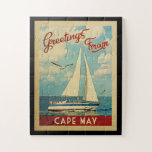 Puzzle Cape May Sailboat Vintage Travel New Jersey<br><div class="desc">Este diseño náutico vintage de Greetings From Cape May New Jersey presenta un barco que navega en el agua con gaviotas y un cielo azul lleno de hermosas nubes blancas.</div>