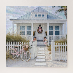 Puzzle Casa de playa blanca con calabazas rosadas y bicic