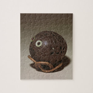 Puzzle El coco esculpió en una cara, c.1895