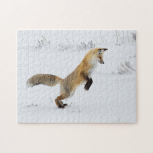 Puzzle El zorro rojo salta en la nieve