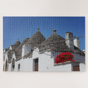 Puzzle Flores de geranio y casas de trullos en Alberobell