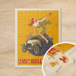 Puzzle La 15hp Bellanger | Leonetto Cappiello<br><div class="desc">La 15hp Bellanger (1921) | El poster publicitario de Leonetto Cappiello para La 15hp Bellanger, de 1921, capta la atención con un diseño audaz e imaginativo. Presenta a una mujer con un vestido amarillo que fluye sentada en lo alto de un globo, soplando un cuerno para anunciar la llegada de...</div>