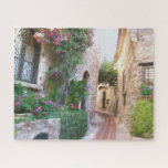 Puzzle La encantadora calle panorámica de la Francia prov<br><div class="desc">Esta hermosa escena está en Provenza, Francia. Disfruta del ambiente y de las flores encantadoras, la serenidad del momento. Cualquier pregunta de diseño, sólo envíe un correo electrónico a charmdesignstudio@rcn.com y estaremos encantados de asistirle. Incluye un funda portador de cartón con imagen de rompecabezas impresa en la tapa; material de...</div>