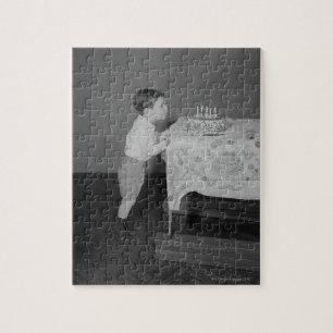Puzzle Muchacho que sopla hacia fuera velas