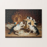 Puzzle Playing Cards | Carl Reichert<br><div class="desc">Playing Cards | Carl Reichert’s Playing Cards is a whimsical and delightful painting featuring three playful cats gathered around a table, seemingly engaged in an intense card game. The cats’ expressive faces and dynamic poses add humor and charm, while the finely detailed setting enhances the scene’s cozy and lighthearted atmosphere....</div>