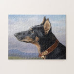 Puzzle Portrait of a Doberman | Carl Reichert<br><div class="desc">Portrait eines Dobermanns (1916) | Carl Reichert’s Portrait eines Dobermanns is a striking side-view portrait of a handsome doberman pinscher dog. The painting showcases the dog’s strong, noble profile and sleek fur with remarkable precision, highlighting its elegance and dignified demeanor. Set against a soft, blue sky background, the artwork emphasizes...</div>