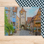 Puzzle Pueblo medieval de Rothenburg ob der Tauber Escena<br><div class="desc">Entra en un mundo de cuento de hadas con este exquisito rompecabezas en el que se encuentra Rothenburg ob der Tauber, Alemania. Esta pintoresca ciudad medieval es famosa por sus encantadoras casas con entramado de madera, sus estrechas calles empedradas y su ambiente romántico, todo capturado con asombroso detalle en esta...</div>