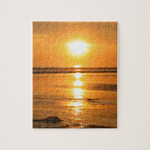 Puzzle Puesta del sol anaranjada hermosa en la playa en
