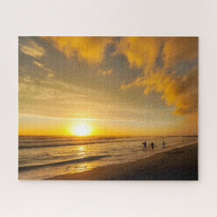 Puzzle Surfista de puesta de sol en la playa