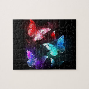 Puzzle Tres mariposas brillantes en el fondo nocturno