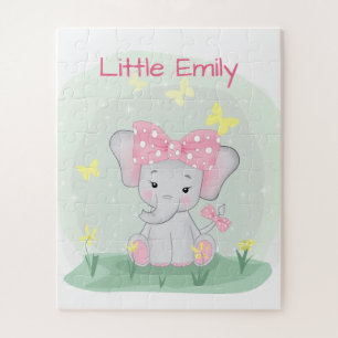 Puzzle Un elefante pequeño con una proa rosa en un claro