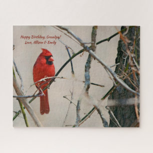 Puzzle Un pájaro cardinal rojo en una rama en las madera