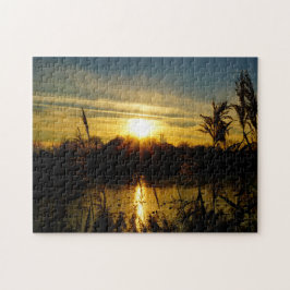Puzzle Zonsondergang bij een meertje met rietpluimen.