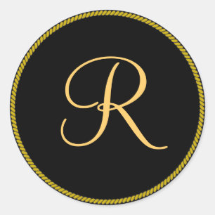 R inicial de color dorado sobre pegatina de monogr