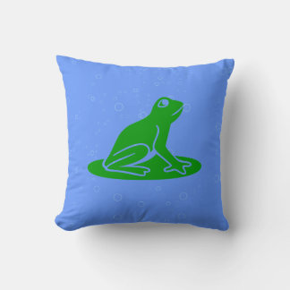 ranas verdes sobre almohada azul