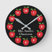 Reloj de aula con manzanas en negro