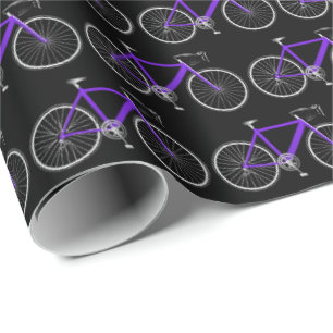 Regalo bicicleta púrpura sobre papel de envoltura negro