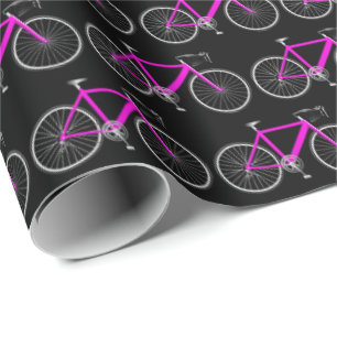 Regalo bicicleta rosa sobre papel de envoltura negro