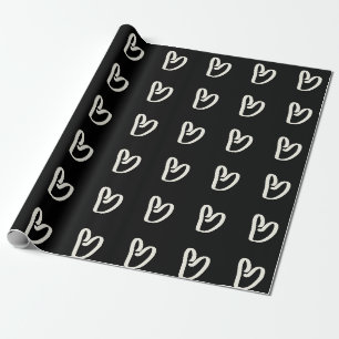 Regalo Corazón blanco sobre papel de envoltura negro