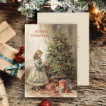 Regalos de Chica de árbol de Navidad vintage<br><div class="desc">Navidades saludando la tarjeta con una pintura vintage de un chica decorando un árbol de Navidad con regalos envueltos debajo. El texto dice "Feliz Navidad" pero es personalizable para tu propio saludo. Personalizado en la parte posterior con su mensaje y nombre. Comuníquese conmigo para obtener ayuda con su personalización o...</div>