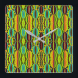 Reloj Cuadrado Afrocentric Geometric Cowrie Shells<br><div class="desc">Bring cultural artistry and modern geometry together with this Afrocentric Geometric Cowrie Shells Square Wall Clock. Designed in an earthy blend of green, orange, blue, burgundy and black, the motif highlights the symbolic beauty of cowrie shells while introducing a structured, contemporary pattern. The result is a striking wall accent that...</div>