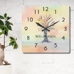 Reloj Cuadrado Árbol arcoiris personalizado<br><div class="desc">Este reloj de pared colorido está decorado con un árbol familiar de mosaicos en los colores del arcoiris sobre un fondo acuarela. Personalizable fácilmente con tu nombre. Porque creamos nuestra propia obra de arte no encontrarás esta imagen exacta de otros diseñadores. Mosaico original y acuarela © Michele Davies.</div>