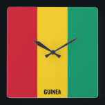 Reloj Cuadrado Bandera de Guinea deslumbrante patriótico<br><div class="desc">Bandera de Guinea Deslumbrando el Reloj de la Plaza Patriótica en los colores y los elementos de la bandera nacional de Guinea cubriendo la parte delantera del reloj. Los colores de la bandera nacional se complementan con el texto "Guinea" en la parte inferior. El texto es totalmente personalizable usando la...</div>