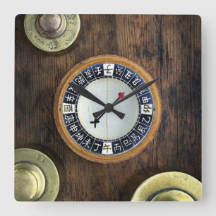 Reloj Cuadrado Close Up Of Chinese Compass And Gold Weights