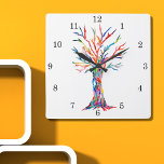 Reloj Cuadrado Cubierta de pared cuadrada del árbol del arcoiris<br><div class="desc">Este reloj caprichoso está decorado con la impresión de un diseño de Tree Of Life en colores arcoiris. El árbol se hizo originalmente en mosaico usando pequeños fragmentos de vidrio de colores brillantes. Porque creamos nuestra propia obra de arte no encontrarás esta imagen exacta de otros diseñadores. Original Mosaico ©...</div>