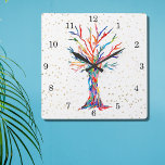 Reloj Cuadrado Estrellas de oro del árbol del arcoiris<br><div class="desc">Este reloj caprichoso está decorado con la impresión de un diseño de Tree Of Life en colores arcoiris y estrellas doradas. El árbol se hizo originalmente en mosaico usando pequeños fragmentos de vidrio de colores brillantes. Porque creamos nuestra propia obra de arte no encontrarás esta imagen exacta de otros diseñadores....</div>