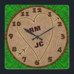 Reloj Cuadrado Heart Carved Initials Wood Tree Rings Personalized<br><div class="desc">This beautiful square wall clock is perfect for a wedding, anniversary or Valentine's Day. The graphic design has a wood texture look, like the top view of a tree stump - complete with rings, a bark border and green grass. A heart with arrow has been carved into the tree, along...</div>