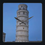 Reloj Cuadrado Leaning Tower at Dusk<br><div class="desc">This captivating photograph showcases the iconic Leaning Tower of Pisa standing elegantly against a deep blue twilight sky in Pisa. The historic marble tower, famous for its unmistakable tilt, is beautifully illuminated, highlighting its intricate Romanesque arches and layered columns. The soft evening light creates a striking contrast between the glowing...</div>