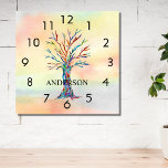 Reloj Cuadrado Nombre Monograma Árbol Arcoiris Cuadrado Cuadrado<br><div class="desc">Este reloj de pared colorido está decorado con un árbol de mosaico en los colores del arcoiris sobre un fondo acuarela. Personalizable fácilmente con su nombre o monograma. Porque creamos nuestra propia obra de arte no encontrarás esta imagen exacta de otros diseñadores. Mosaico original y acuarela © Michele Davies.</div>