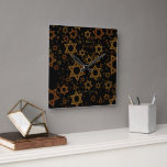 Reloj Cuadrado SlipperyJoe's Estrella David temática de Hanukkah<br><div class="desc">SlipperyJoe's Estrella David temática de Hanukkah artística luz de velas festiva resplandeciente temas de luz y resiliencia modernos reverentes para festividades judías tamaños variados tonos metálicos oro bronce marrón profundo negro rico fondo evoca elegancia tradición hebrea patrón simétrico regalos decoraciones flujo visual ceremonial rítmico símbolo significativo religión</div>