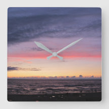 Reloj de pared acrílico con puesta de sol en el la